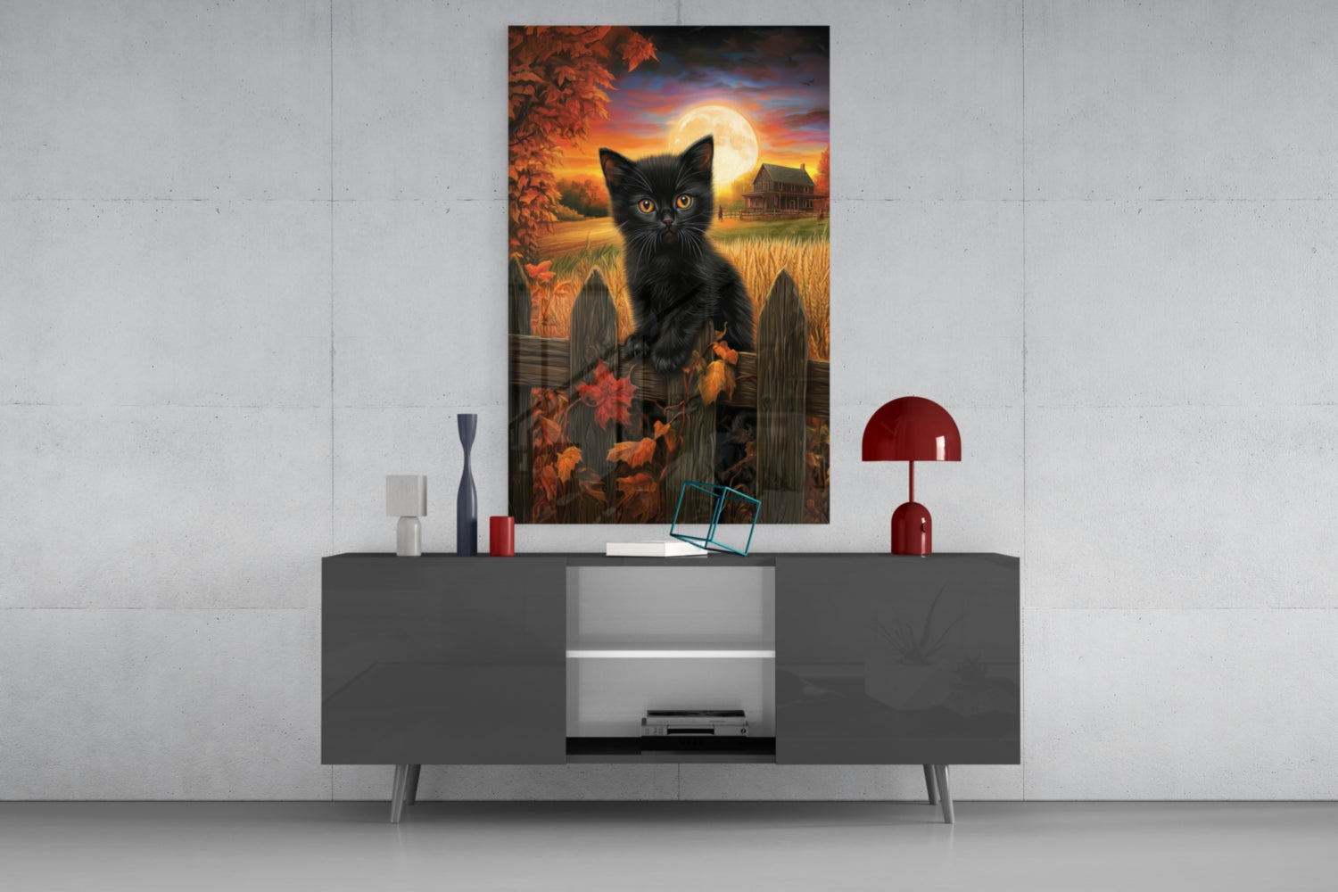 Black cat with glowing eyes in autumn harvest scene with full moon, displayed above gray media console in modern interior setting.