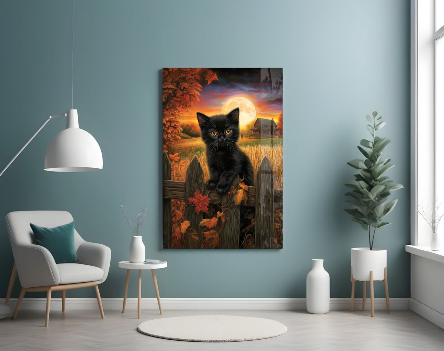 Black cat glass wall art depicting autumn moonlit landscape displayed above white chair in minimalist teal room.