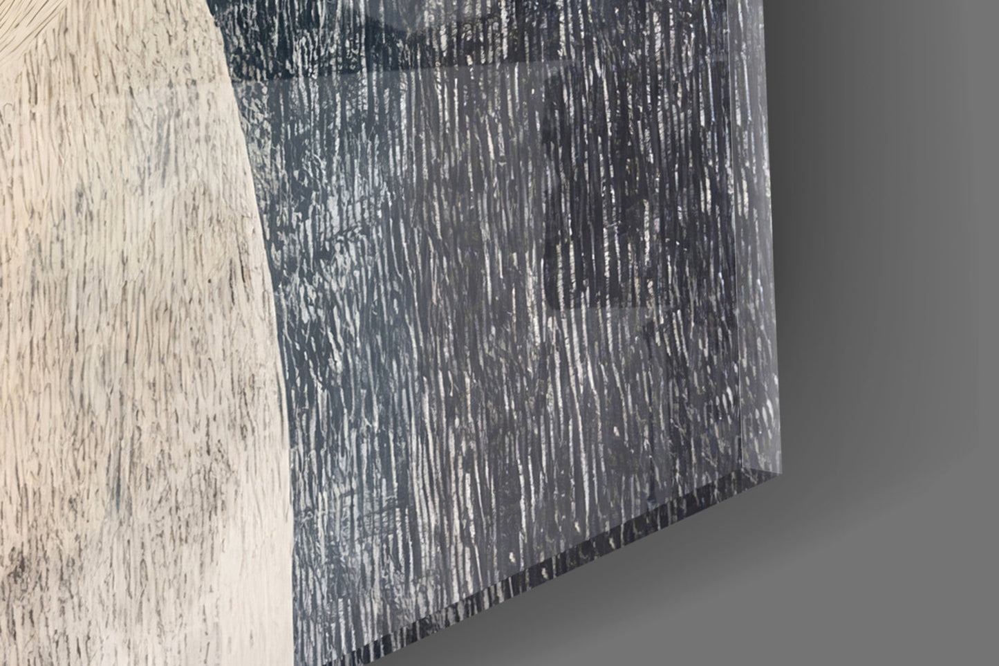 Close-up angled view of glass wall art showing textured brushstroke pattern in dark charcoal and white tones.