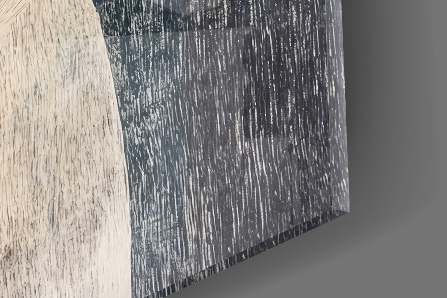 Close-up angled view of glass wall art showing textured brushstroke pattern in dark charcoal and white tones.
