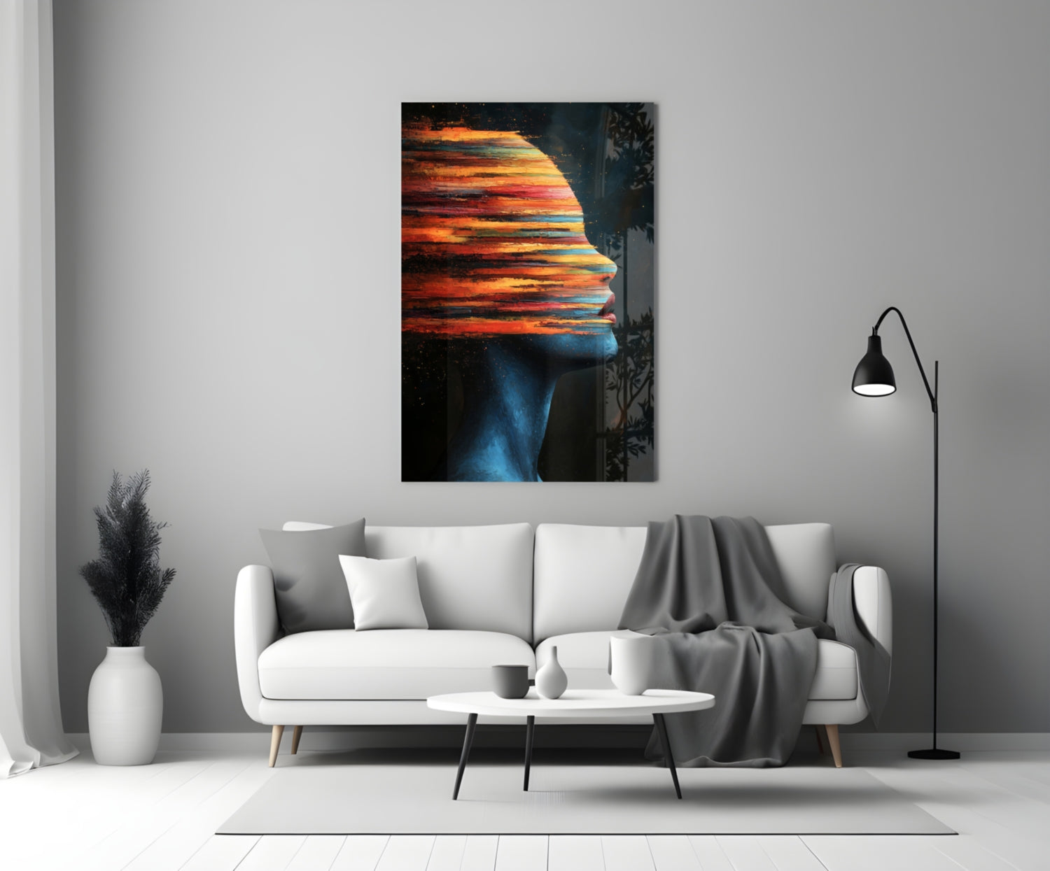 Modern living room with white sofa displaying colorful sunset landscape glass wall art above.