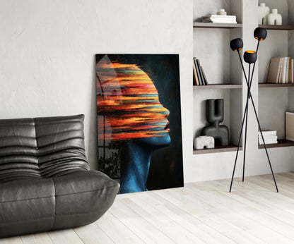 Modern living room interior featuring a glass wall art depicting a colorful sunset profile silhouette next to gray leather furniture and shelving.