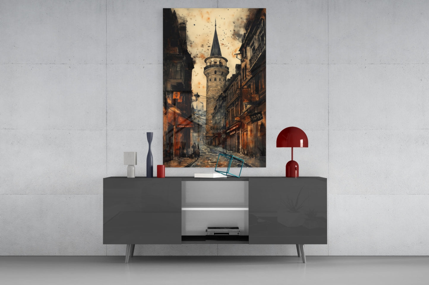 Galata Street Glass Wall Art mounted above gray media console with red lamp and decorative objects, showing Istanbul tower street scene in sepia tones.