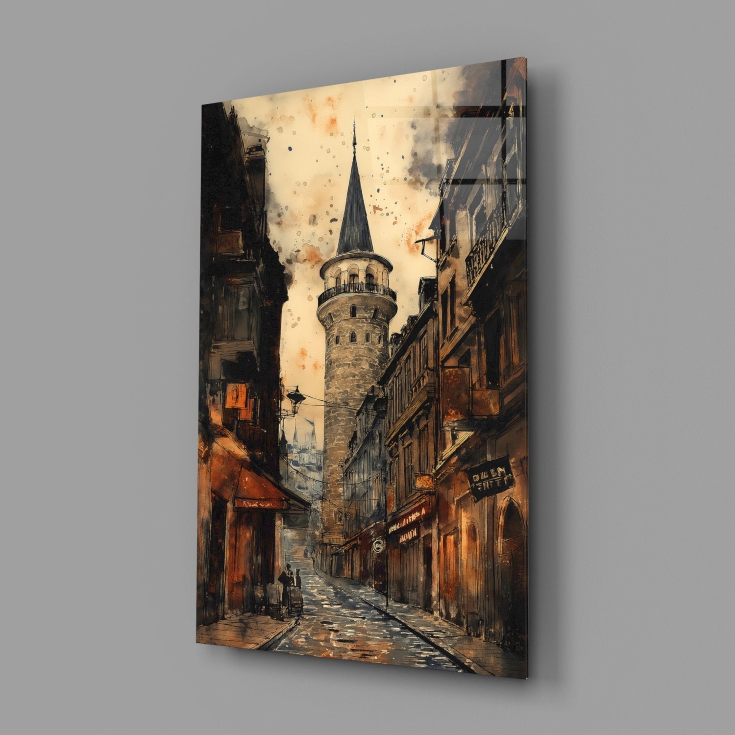 Glass wall art depicting a narrow Istanbul street with historic buildings in warm oranges and browns, centered on the Galata Tower with a pointed spire against a cloudy sky.