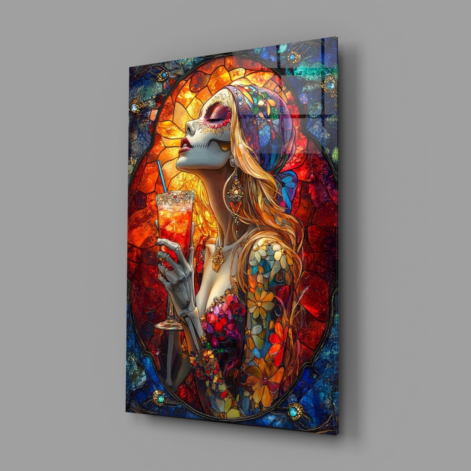 Angled view of glass wall art featuring a stylized female figure with stained glass halo, holding a cocktail glass, surrounded by vibrant orange, red, and blue tones.