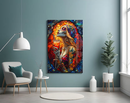 Colorful stained glass-style wall art featuring a skull-faced woman with orange and red tones displayed in a modern room setting.