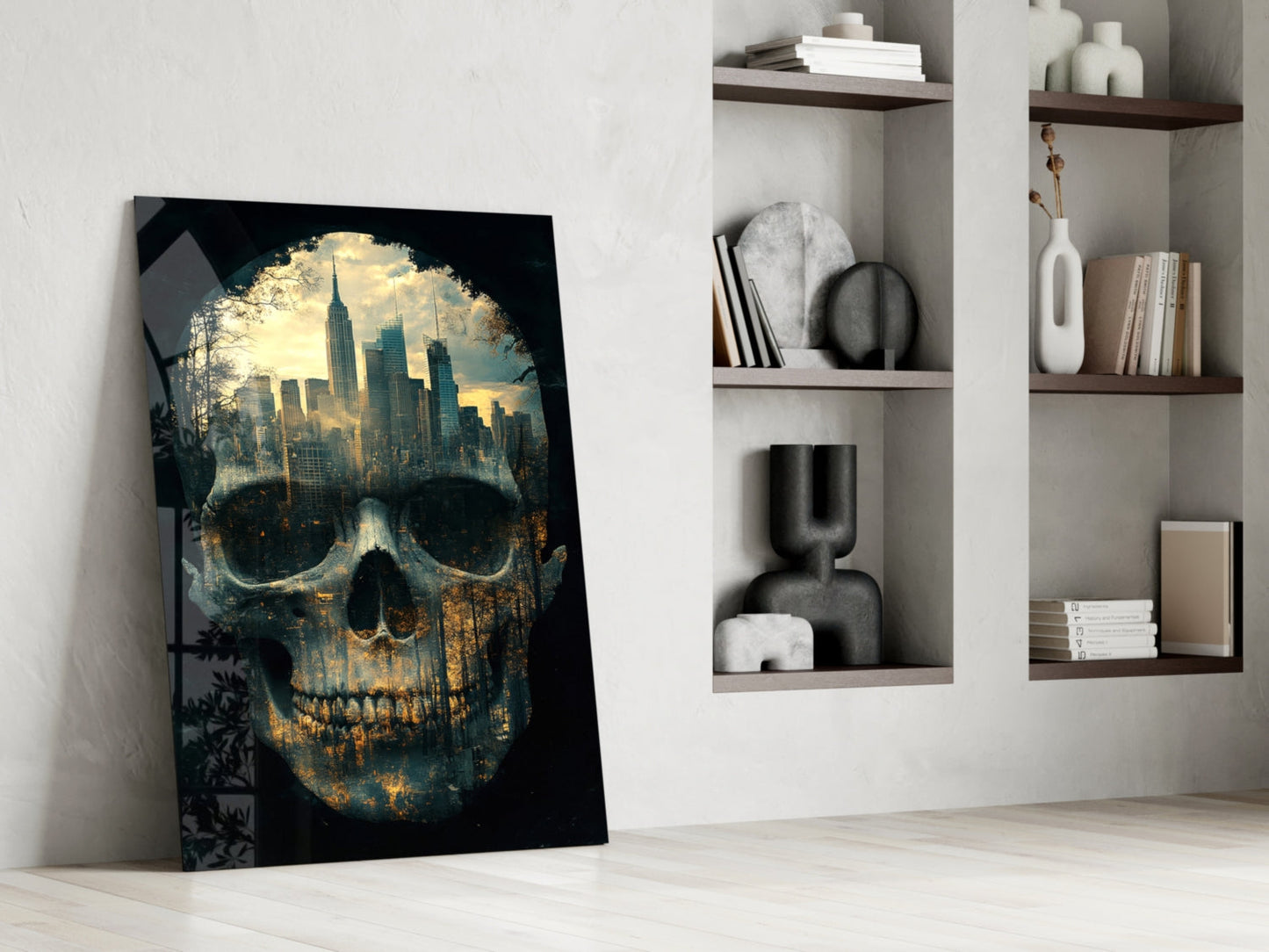 Glass wall art leaning against white wall displays skull with golden cityscape and dark foliage overlay.