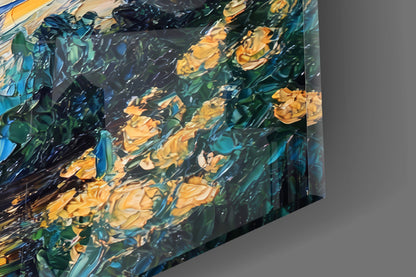 Close-up angled view of glass art showing swirling yellow flowers and blue-green brushstrokes with reflective surface detail.