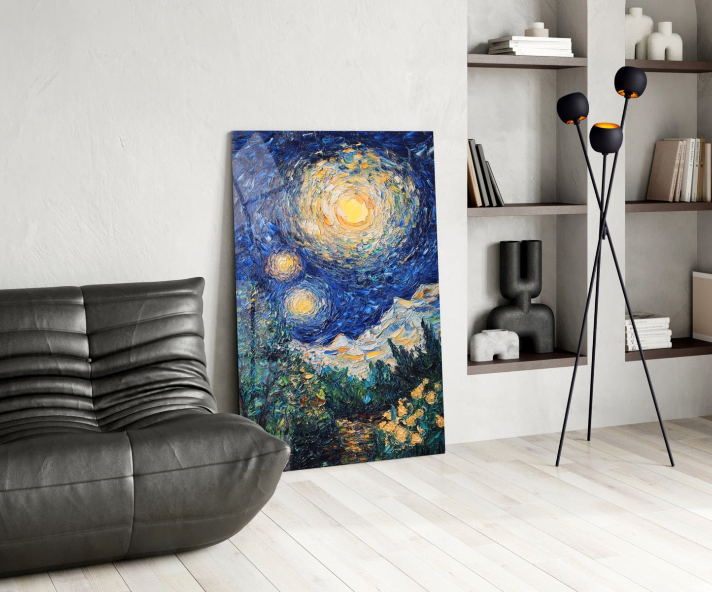 Modern living room interior featuring Van Gogh's Starry Night glass art leaning against wall beside black leather chair and floor lamp.