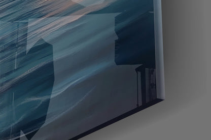 Close-up angled view of glass wall art showing layered sailboat silhouettes in blue and teal tones with wood grain texture.