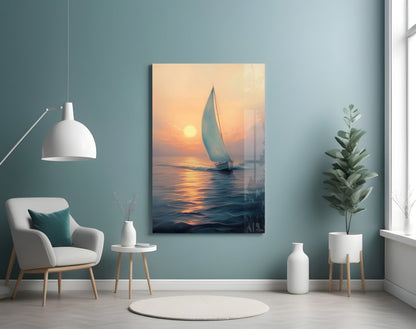 Sailboat glass wall art depicting a golden sunset over calm water, displayed in a modern room with teal walls, white furniture, and potted plants.