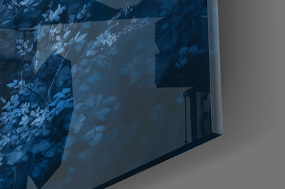 Blue deer glass wall art with botanical foliage etching displayed on white wall, angled perspective view.