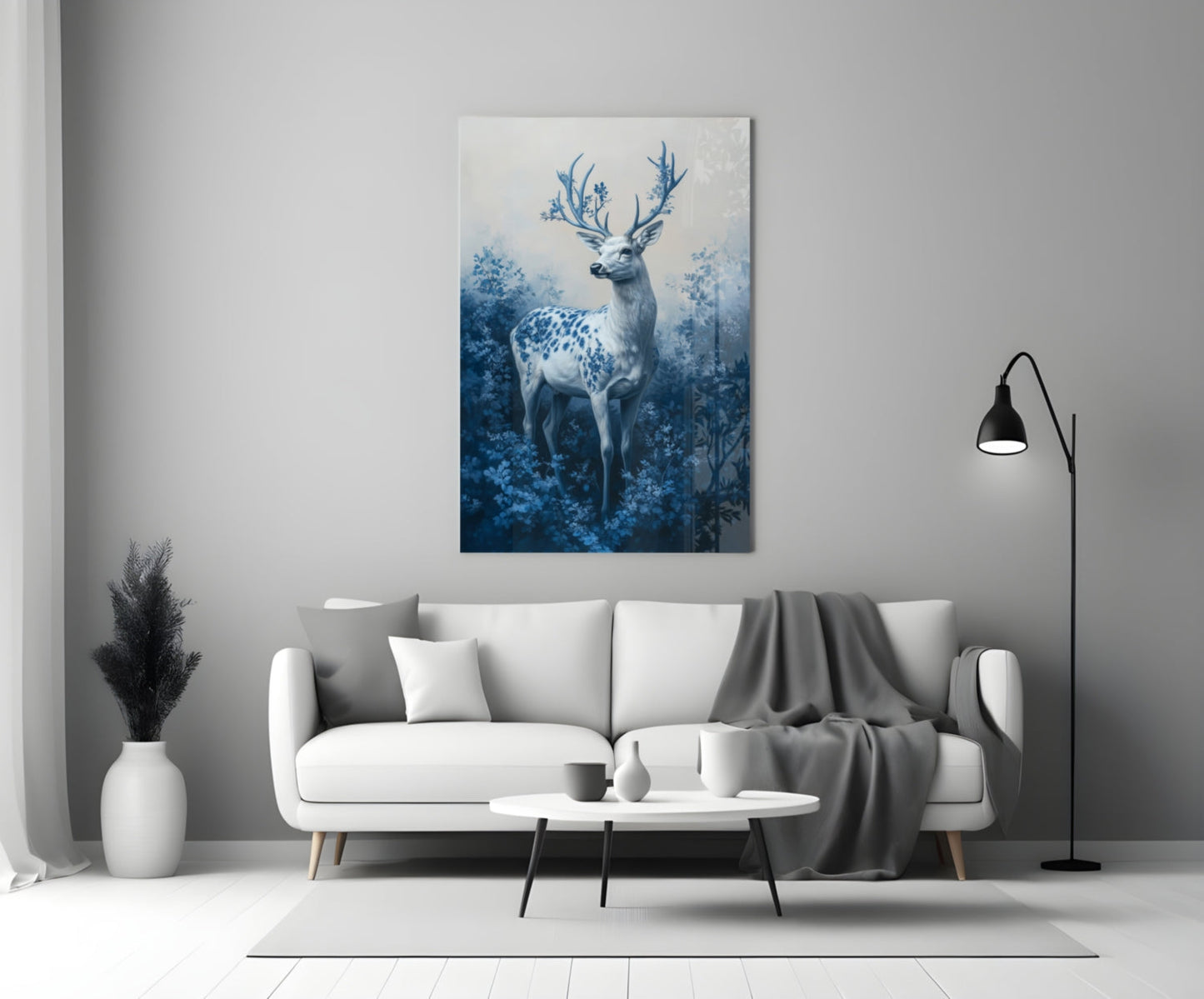 Blue deer glass wall art hanging above white sofa in minimalist living room interior.