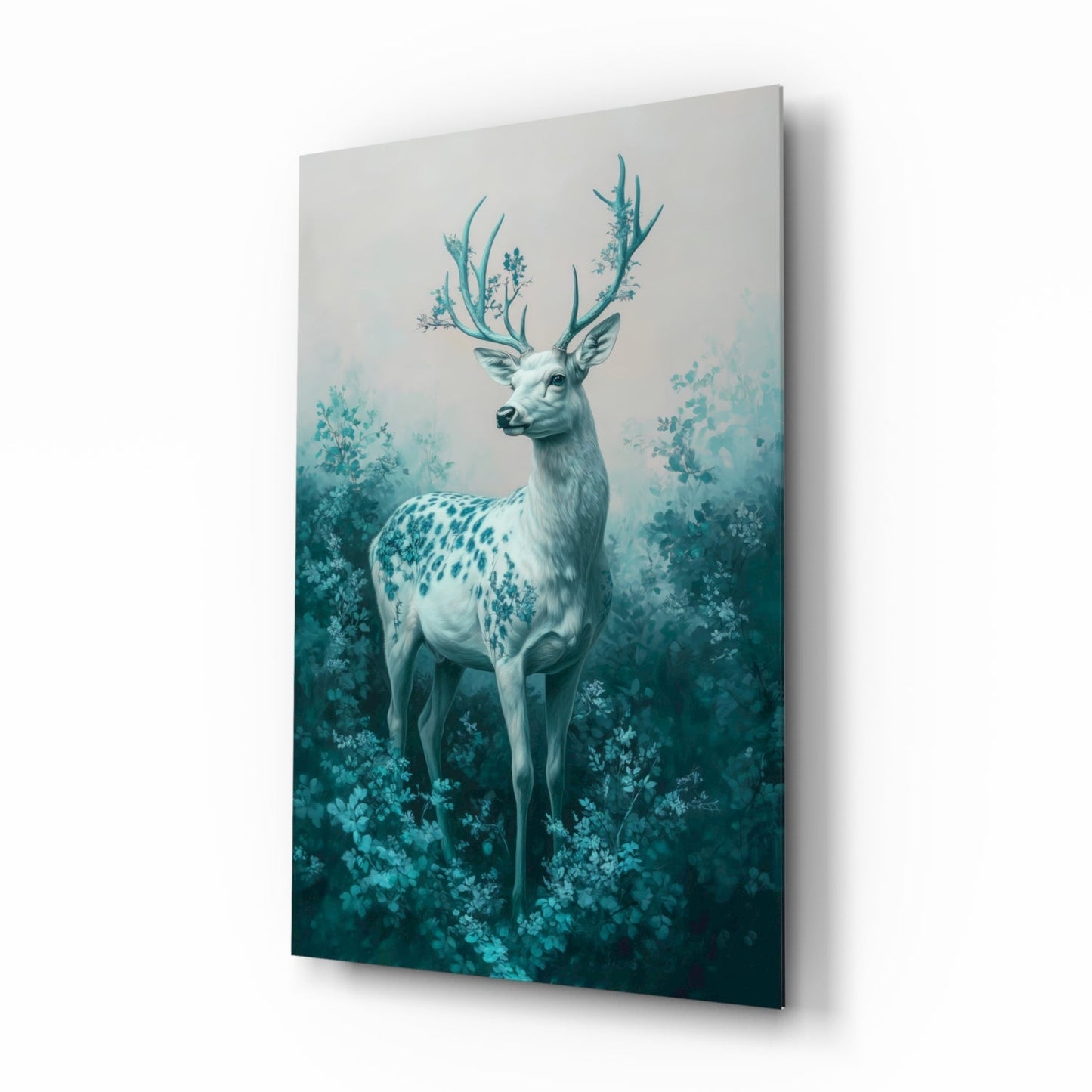 Angled view of glass wall art featuring a white deer with turquoise antlers surrounded by misty teal foliage.