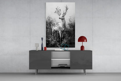 Monochrome deer glass wall art displayed above a dark gray console table with red and white decorative accessories in a modern interior setting.