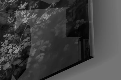 Shadow cast by monochrome deer glass wall art displaying detailed botanical foliage patterns on white wall surface.