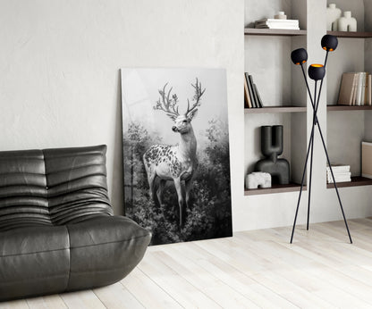 Black and white deer artwork leaning against white wall in modern living room with gray leather chair and shelving.