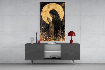 Golden Prayers of Mary glass wall art displayed above a dark gray media console with red decorative lamps and accessories.
