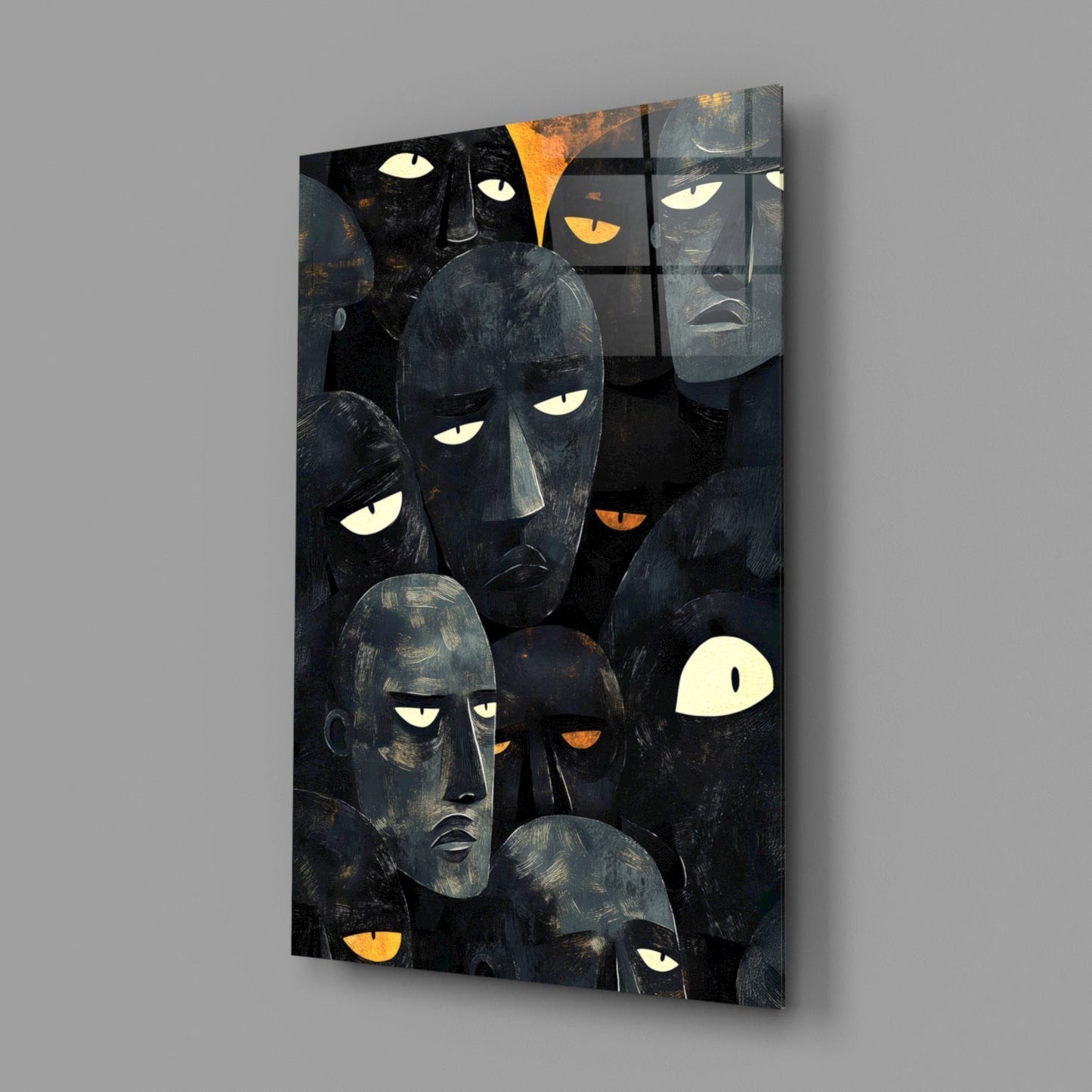Black glass wall art panel displaying multiple stylized faces with glowing white and orange eyes against dark background, angled three-quarter view.