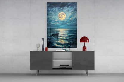 Glass wall art depicting a moonlit seascape with a boat, displayed above a gray media console in a modern interior setting.