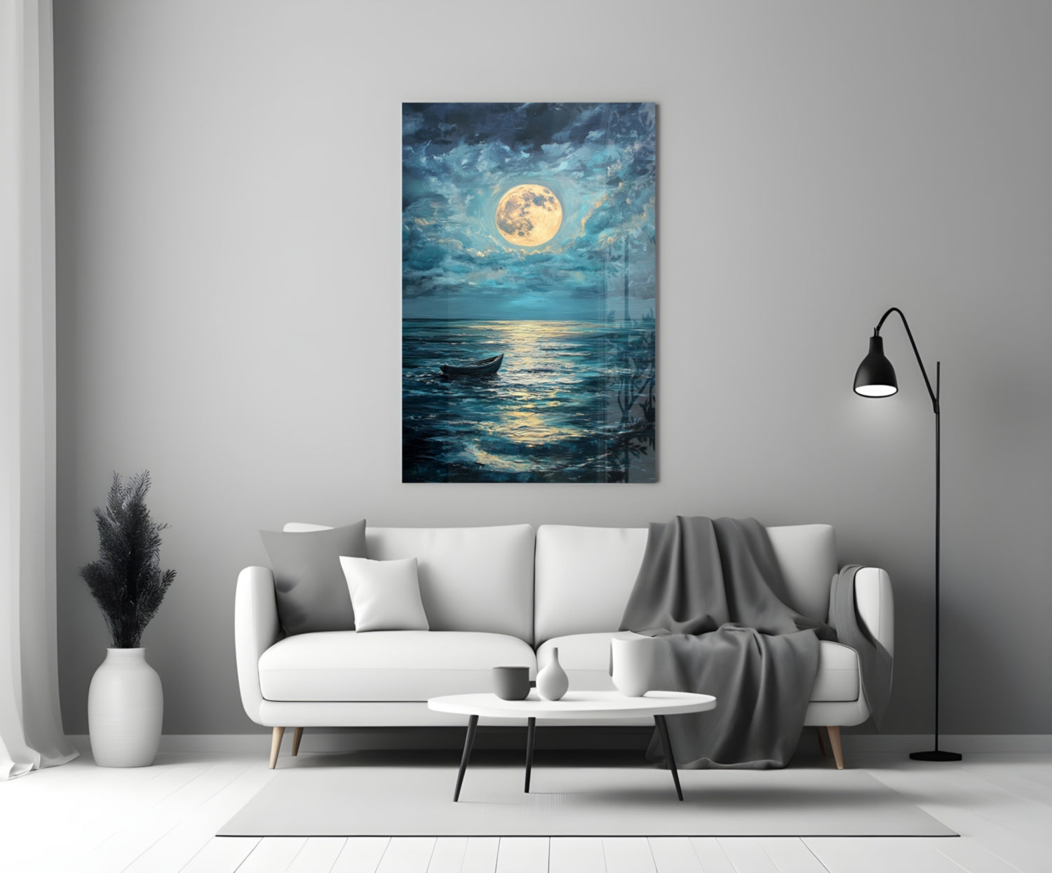 Full moon glass wall art depicting a moonlit seascape with a lone boat, displayed above a white sofa in a modern living room.