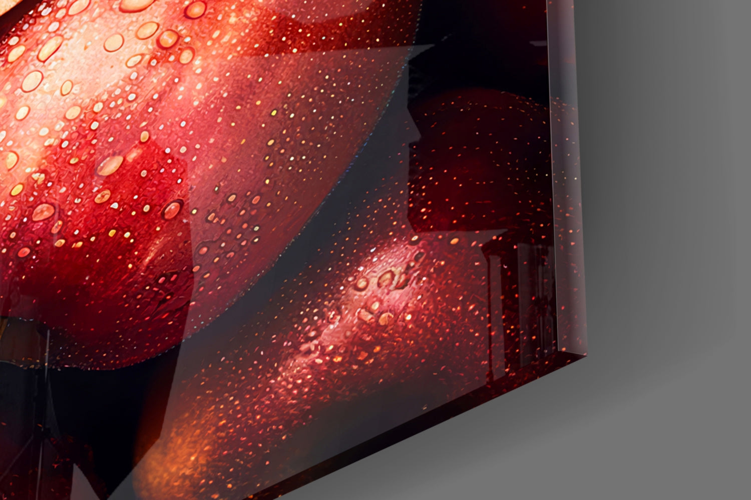 Close-up detail of red glass wall art with water droplets and reflective surfaces catching warm light.