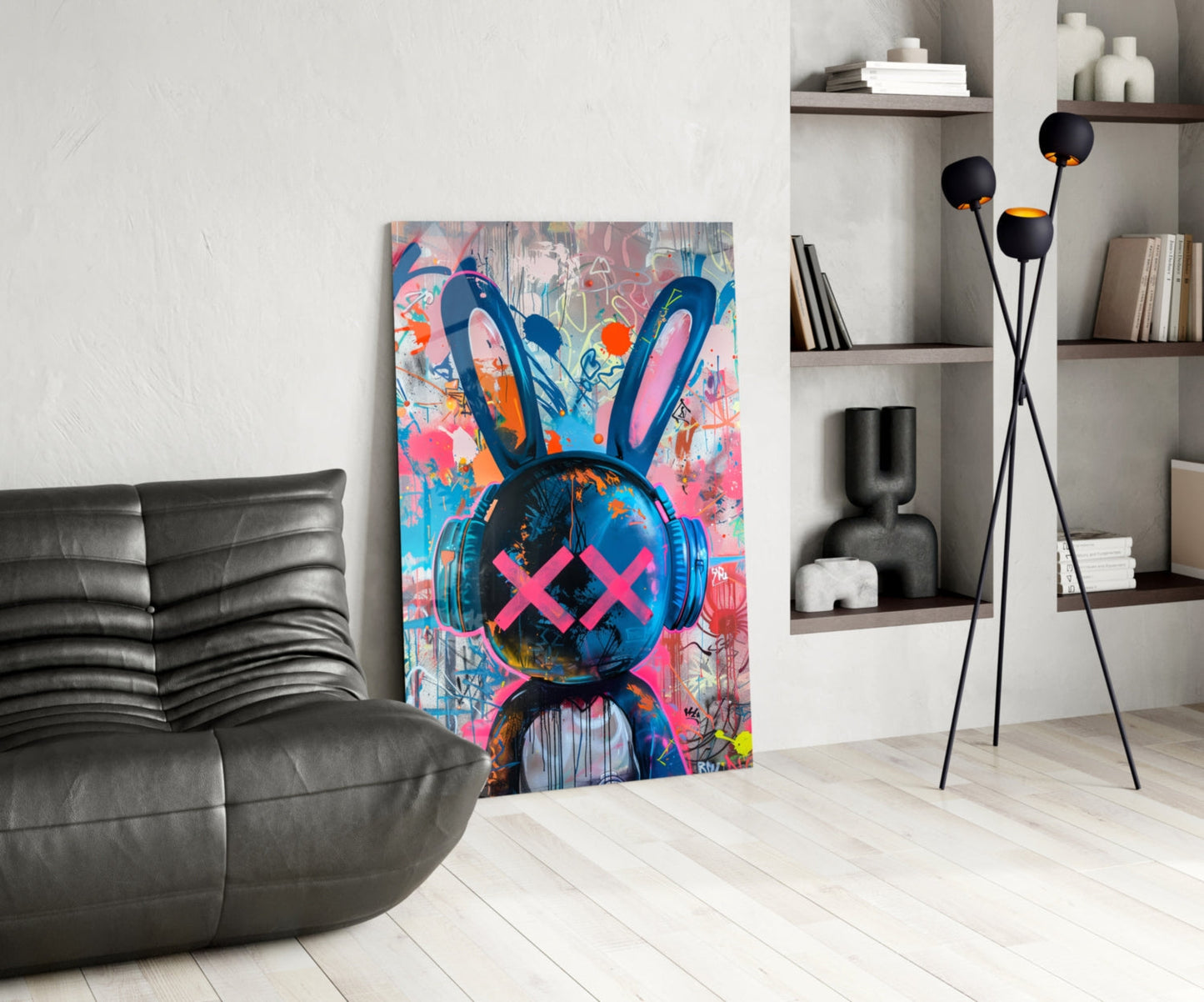 Colorful graffiti rabbit glass art with blue headphones and pink X eyes displayed in modern living room with gray sofa and shelving.