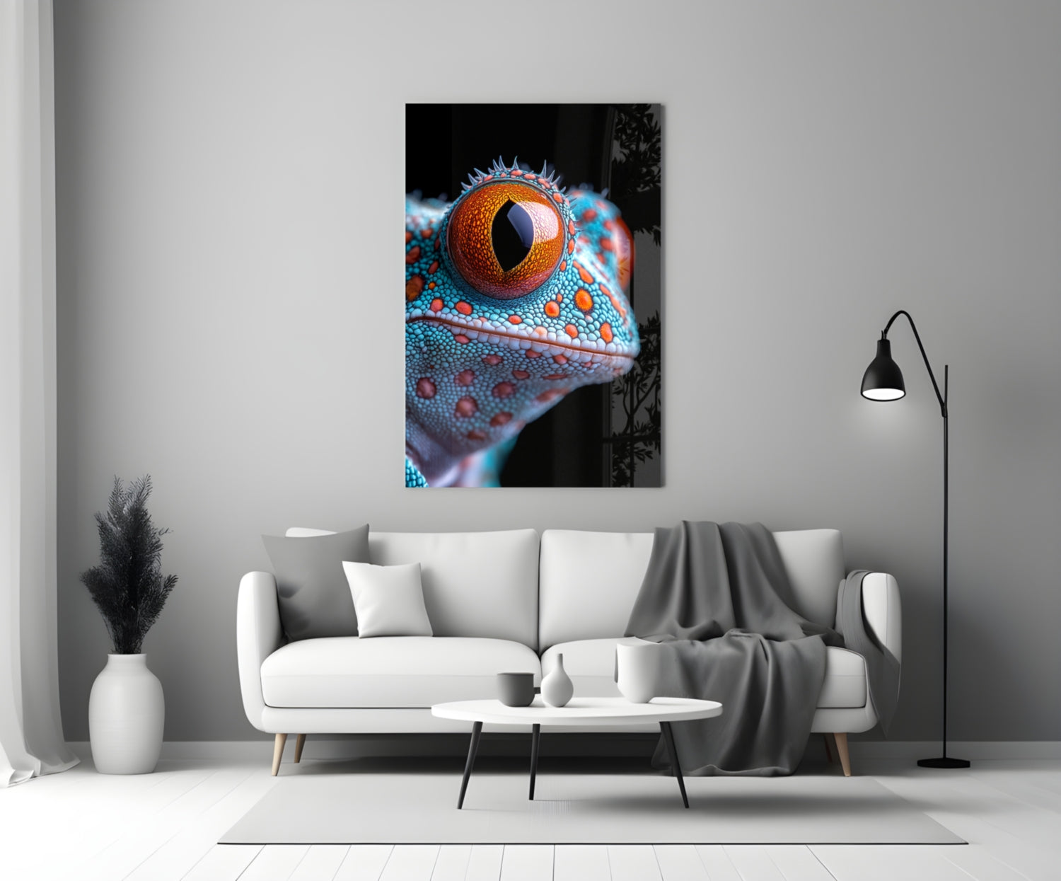 Framed glass wall art depicting a close-up of a reptile's head with vibrant turquoise scales and a striking orange eye displayed above a white sofa.