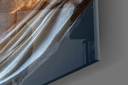 Close-up angled view of whitewashed wooden ceiling beams with glass wall art casting dark shadow below.