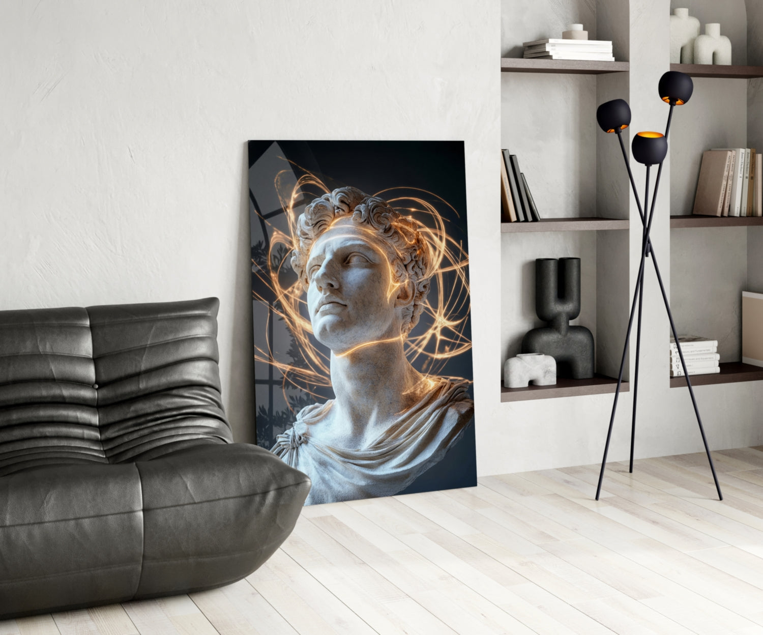 Modern living room with classical marble bust artwork featuring golden light effects, displayed leaning against white wall beside black leather chair and floor lamp.