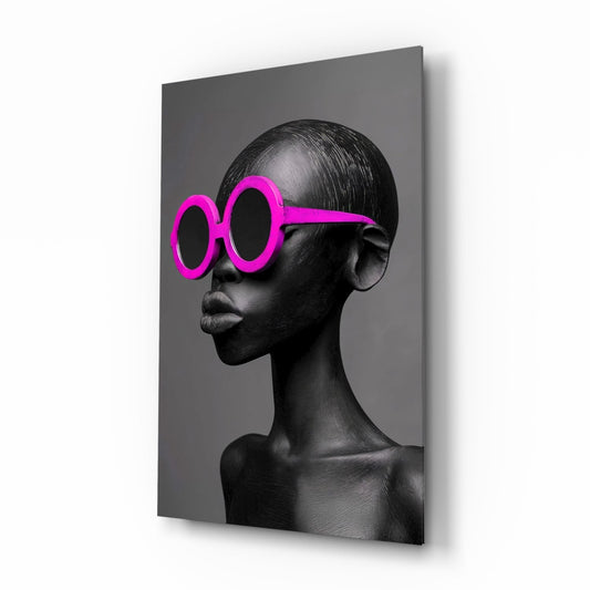 Profile view of a sculptural head wearing oversized hot pink round sunglasses against a gray background on glass.