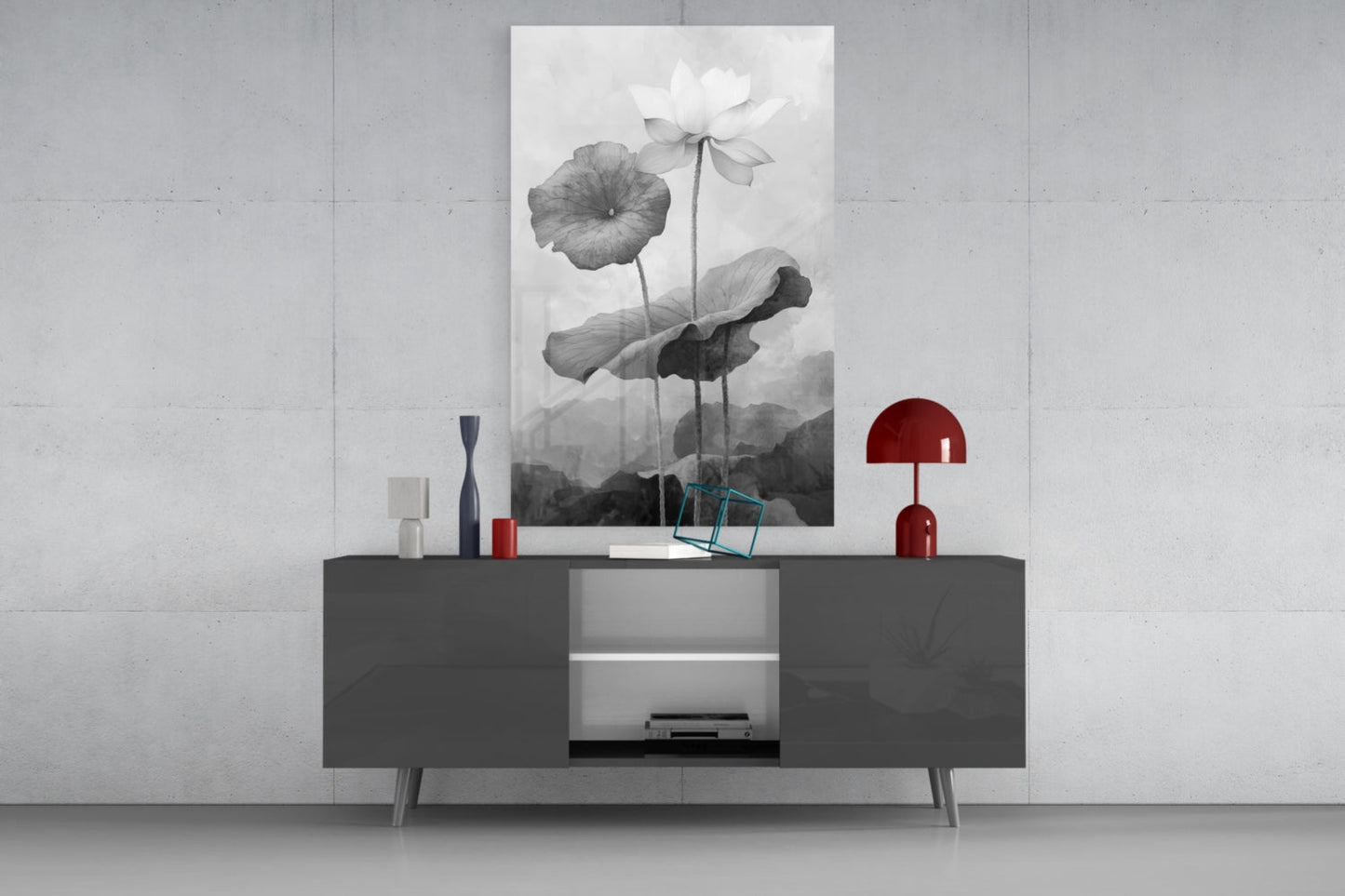 Black and white water lily glass wall art displayed above a dark gray sideboard with red decorative accents in a minimalist interior.