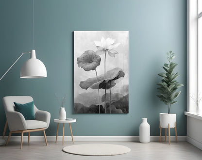 Black and white water lily glass wall art displayed on a teal accent wall in a minimalist room setting with furniture and plants.