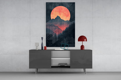 Red Moon Rising glass wall art displayed above a dark gray media console with decorative accessories in a minimalist interior setting.