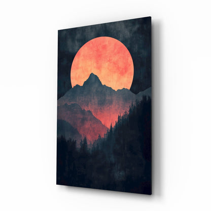 Glass wall art panel displaying a large coral-red moon rising behind a dark mountain silhouette and forested landscape.