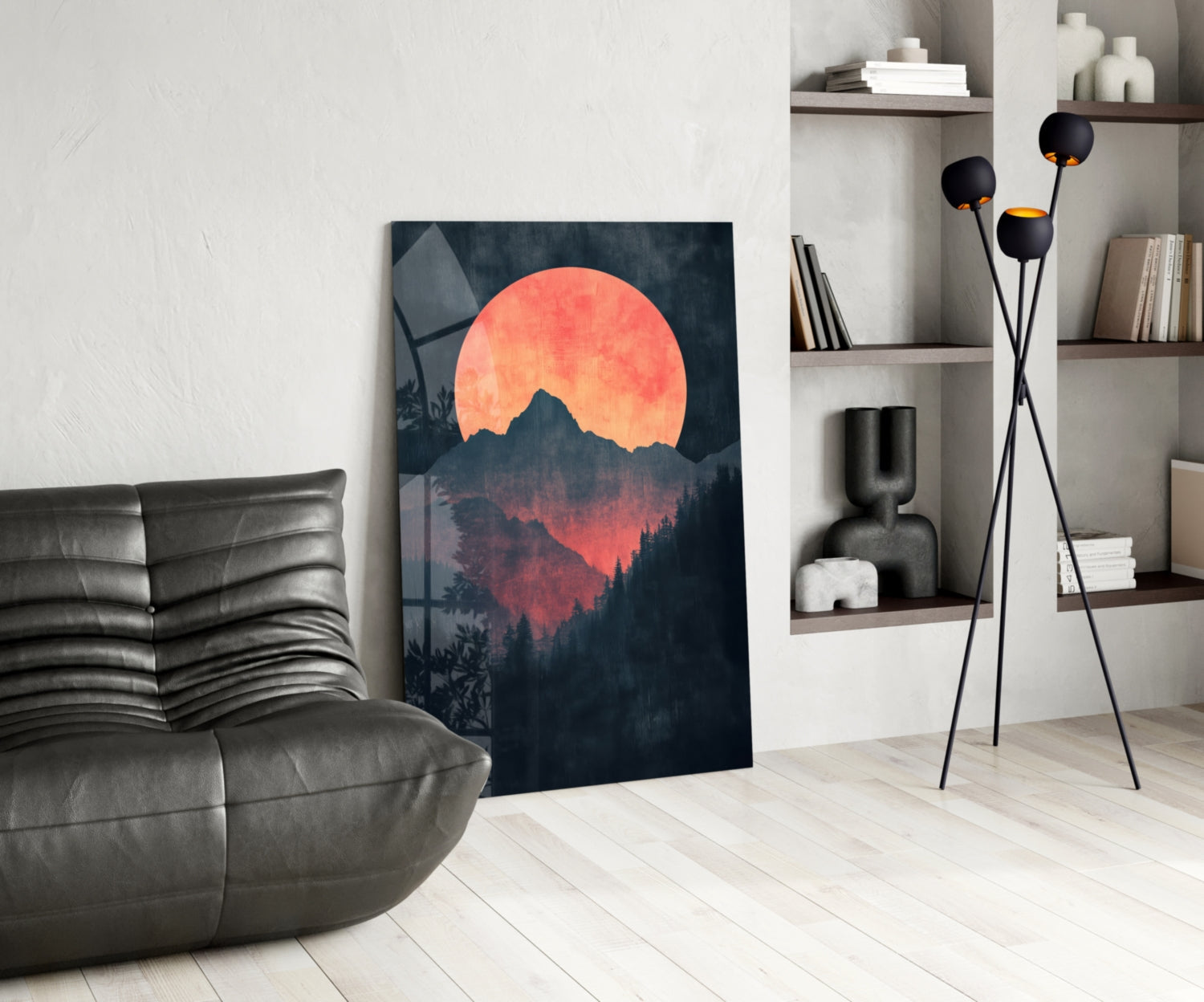 Modern living room interior featuring Red Moon Rising glass wall art leaning against white wall beside gray leather chair.