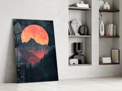 Red moon rising glass wall art leaning against white wall beside built-in shelving with decorative objects and books.