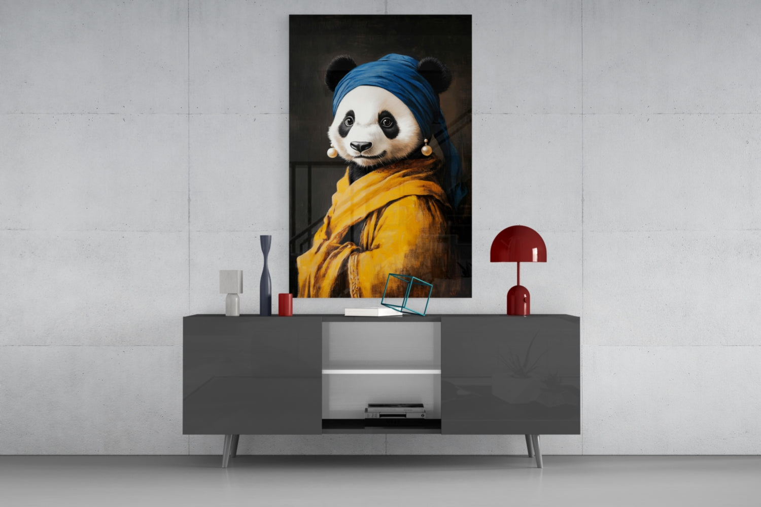 Glass wall art depicting a panda wearing a blue headwrap and yellow garment with pearl earrings, displayed above a dark console table in a modern interior setting.
