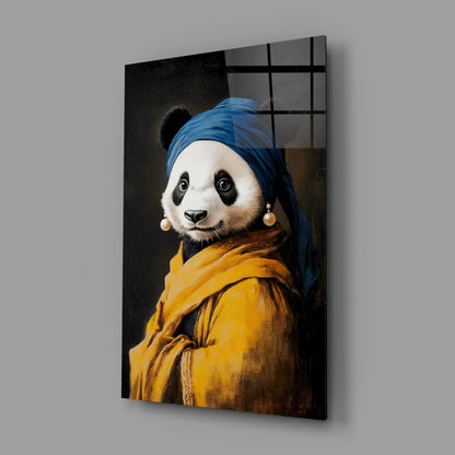 Glass wall art panel displaying a panda wearing a blue headwrap and yellow jacket with pearl earrings, angled view showing depth and shadow.