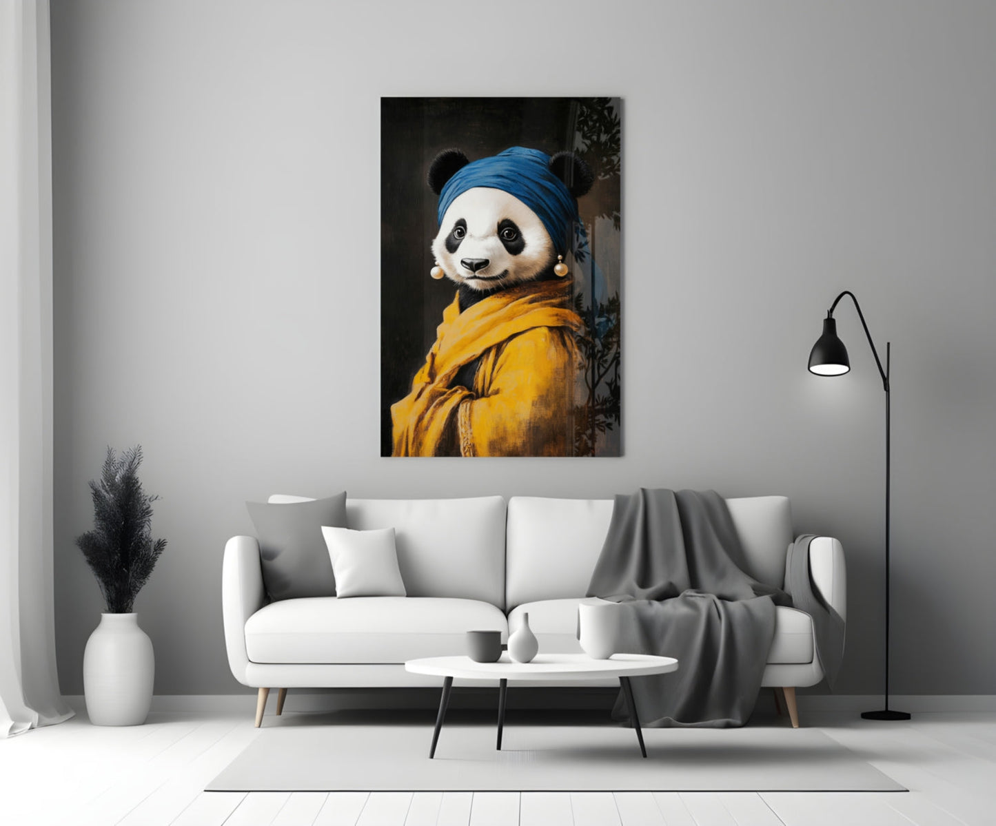 Glass wall art depicting a panda wearing a blue headwrap and yellow jacket with pearl earrings, displayed above a white sofa in a modern living room.