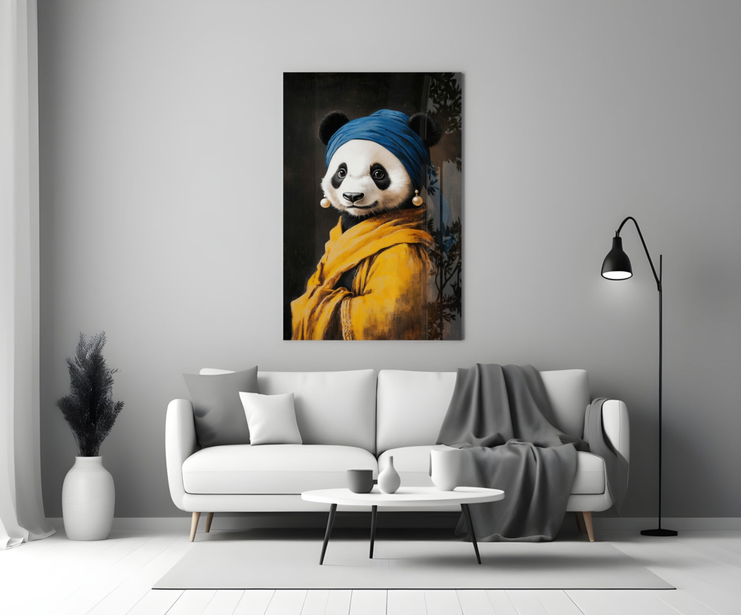 Glass wall art depicting a panda wearing a blue headwrap and yellow jacket with pearl earrings, displayed above a white sofa in a modern living room.