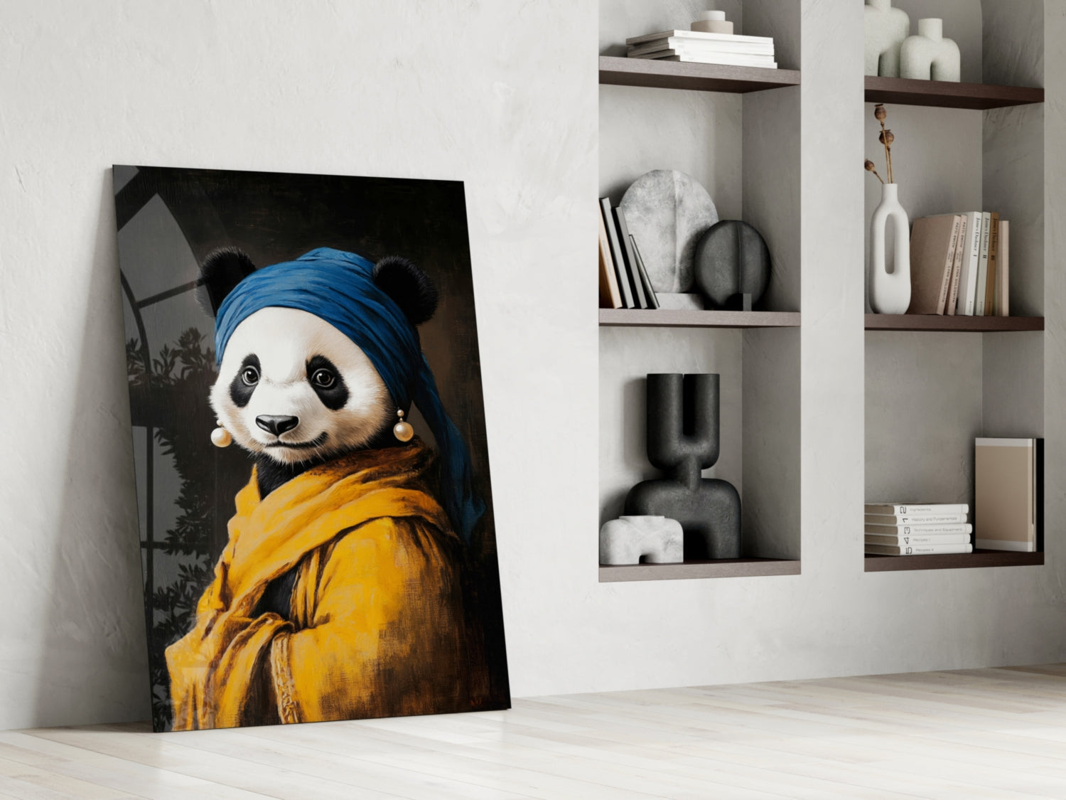 Glass wall art leaning against white wall displays panda wearing blue headwrap, yellow jacket, and pearl earrings against dark background.