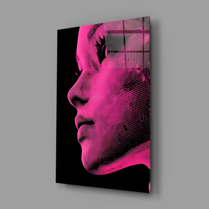Angled perspective view of pink and black halftone portrait glass wall art displaying a woman's profile against gray background.