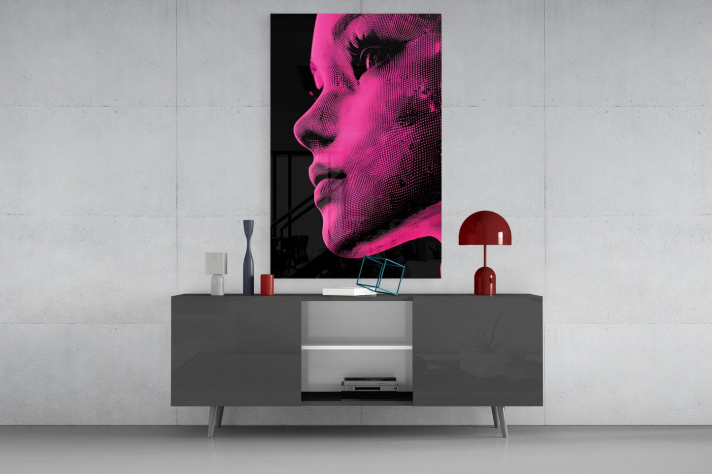 Modern living room display featuring pink and black halftone portrait glass wall art mounted above gray media console with decorative objects.