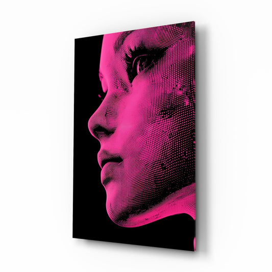 Angled view of a glass wall art panel featuring a pink and black halftone portrait of a woman's face in profile against a black background.
