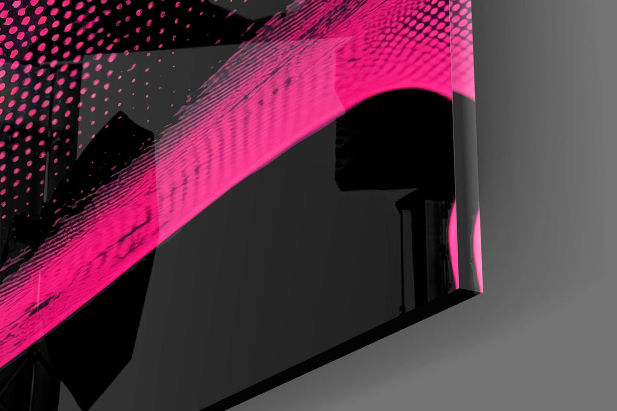 Close-up angled view of bright pink glass wall art with black dotted and linear pattern details against gray background.