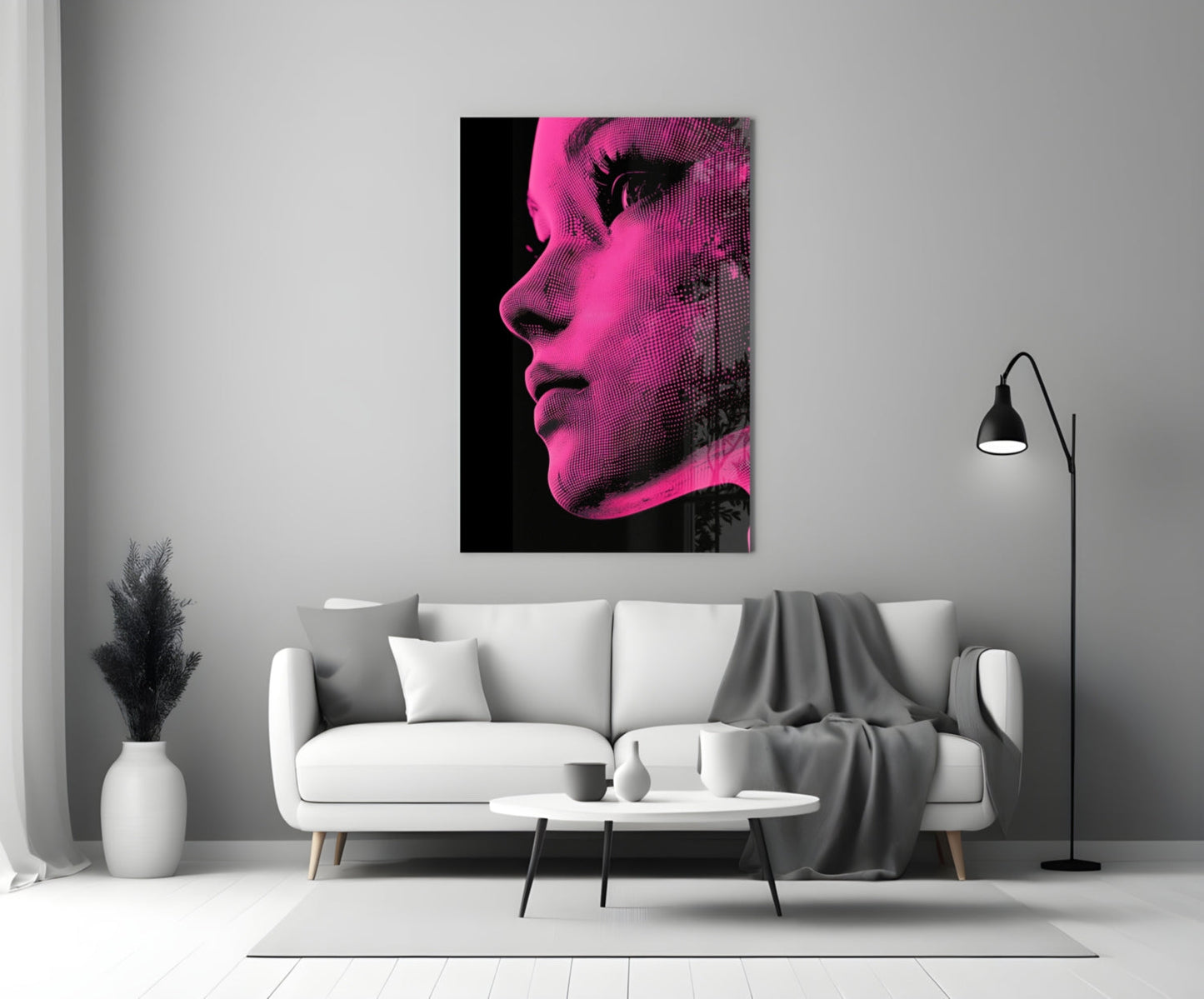 Pink and black halftone portrait glass wall art displayed above a white sofa in a modern living room.