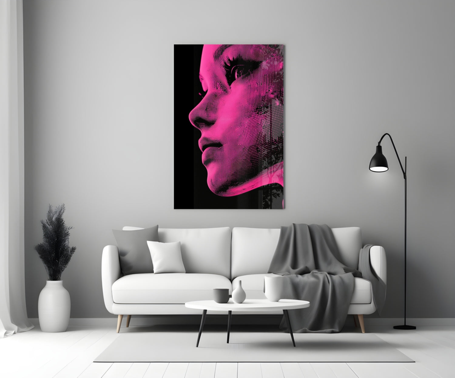 Pink and black halftone portrait glass wall art displayed above a white sofa in a modern living room.