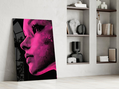 Bold pop art portrait in neon pink and black halftone dots leaning against white wall beside built-in shelving.