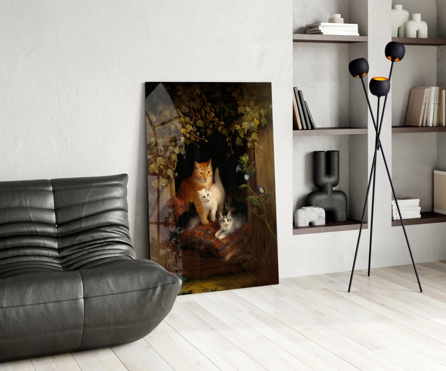 Glass wall art depicting a mother cat and two kittens in a window with golden foliage, displayed in a modern living room setting.